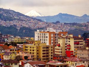 View of Quito, Ecuador with a snow-capped volcano in the distance.